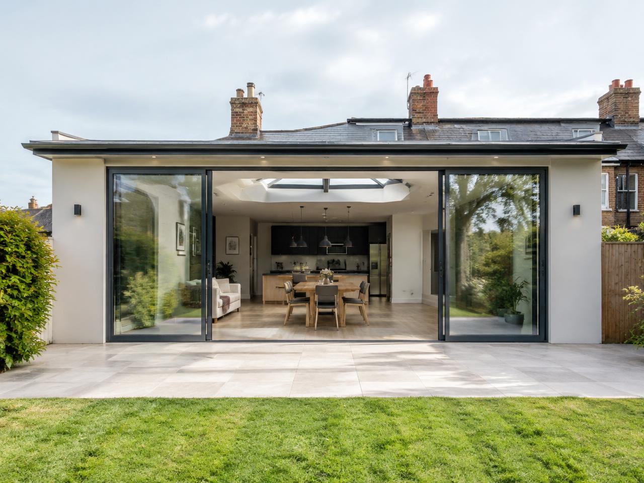 Modern rear home extension with sliding glass doors and roof lantern